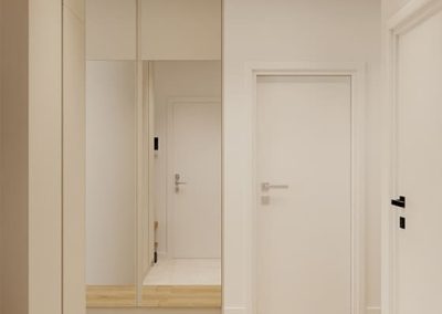 Lustro i szafa w strefie wejściowej zaprojektowane przez architekta wnętrz z myślą o mieszkaniu pod klucz.